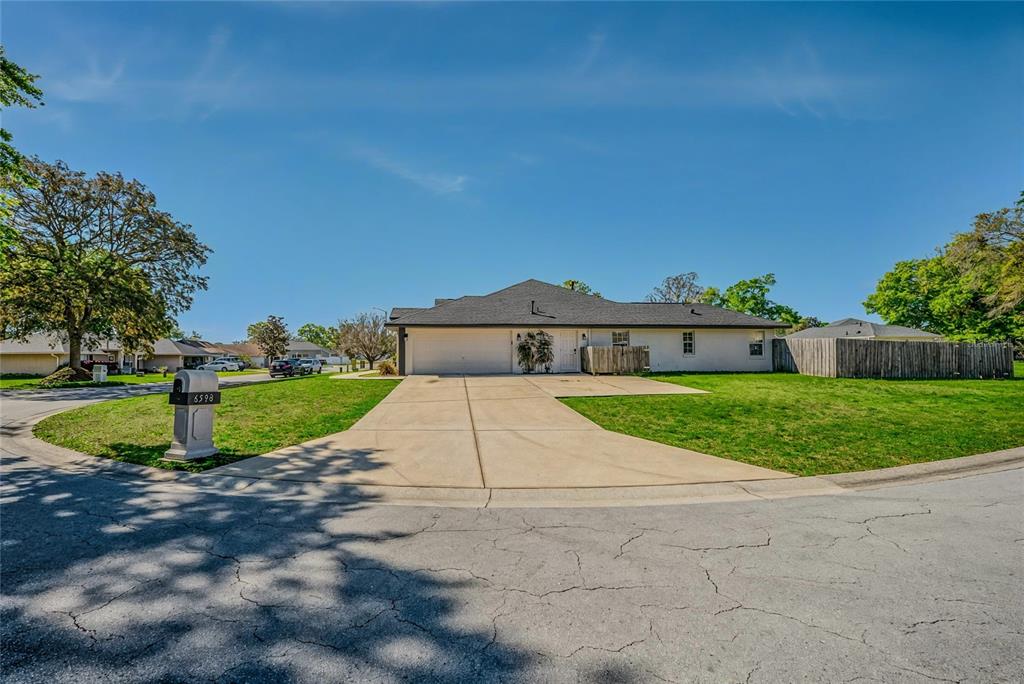 6598 Southeast 11th Loop Ocala, FL 34472 - Photo 42 of 49 a front view of a house with a yard