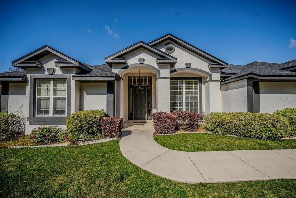 6598 Southeast 11th Loop Ocala, FL 34472 - Photo 43 of 49 a front view of a house with garden