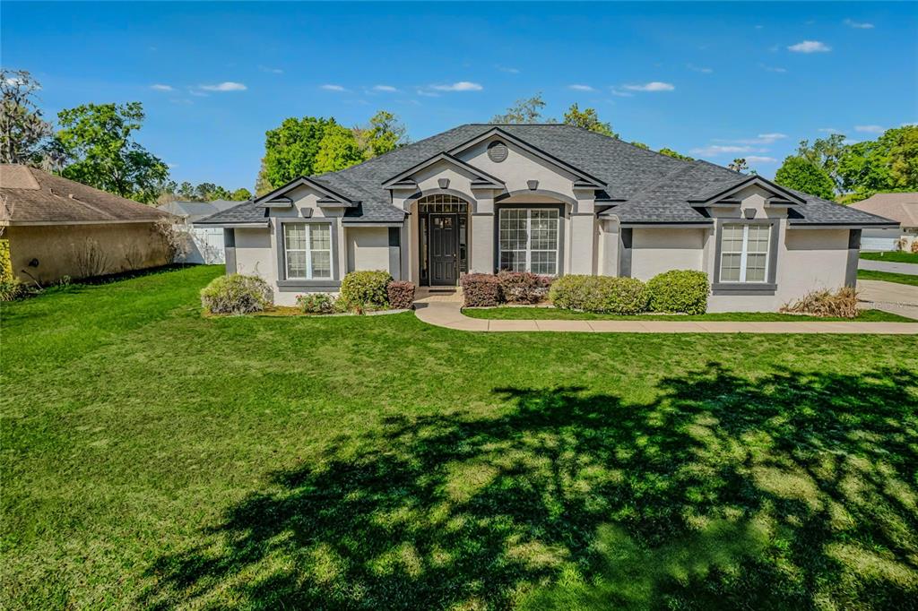 6598 Southeast 11th Loop Ocala, FL 34472 - Photo 45 of 49 a front view of a house with a yard