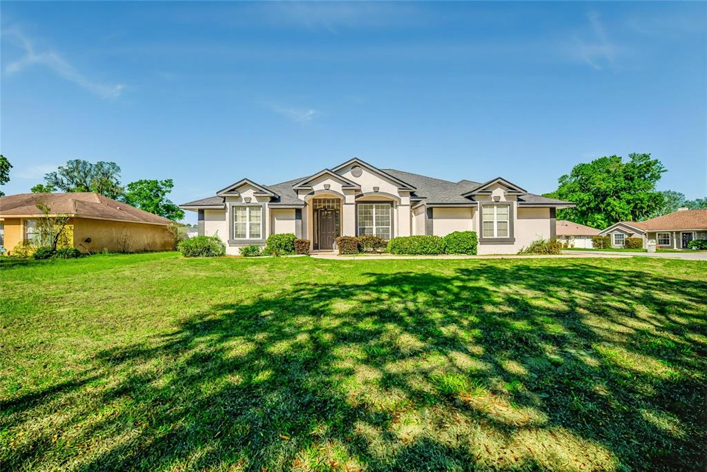 6598 Southeast 11th Loop Ocala, FL 34472 - Photo 48 of 49 a front view of a house with garden