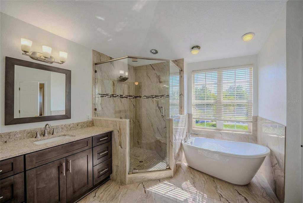 6598 Southeast 11th Loop Ocala, FL 34472 - Photo 7 of 49 a bathroom with a granite countertop sink a toilet and shower