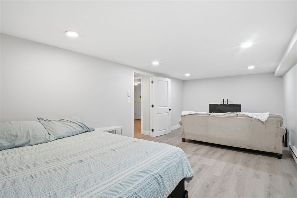 382 North Brook Road Springfield, MA 01119 - Photo 23 of 31 a spacious bedroom with a bed and a couch