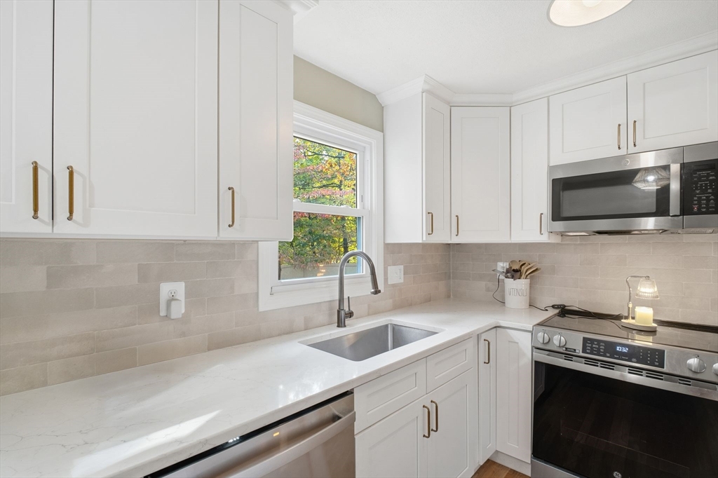 382 North Brook Road Springfield, MA 01119 - Photo 9 of 31 a kitchen with stainless steel appliances granite countertop a sink a stove and microwave