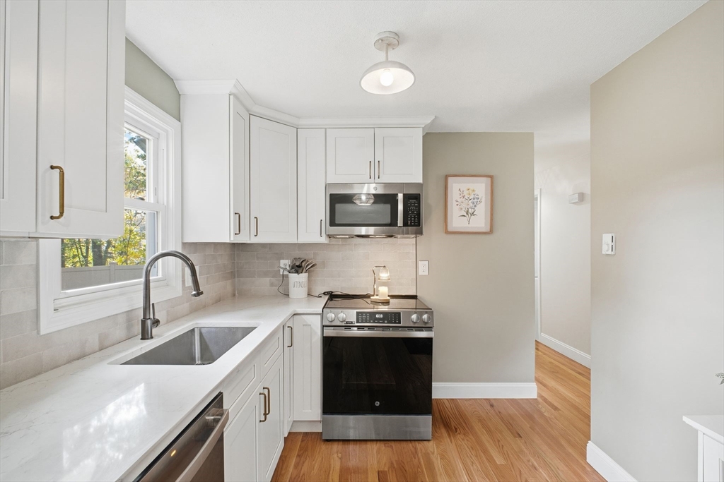 382 North Brook Road Springfield, MA 01119 - Photo 10 of 31 a kitchen with stainless steel appliances a stove sink microwave and cabinets