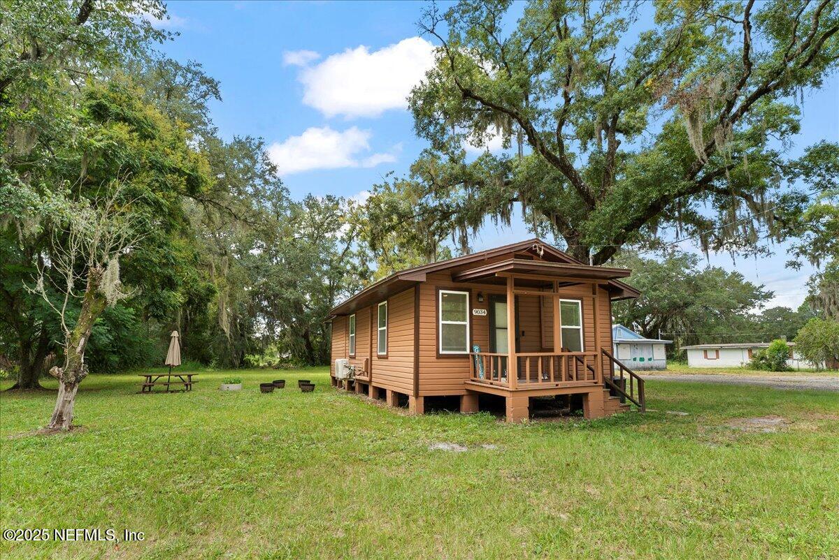 9034 Crystal Springs Road Jacksonville, FL 32221 - Photo 1 of 34 a view of a house with a yard