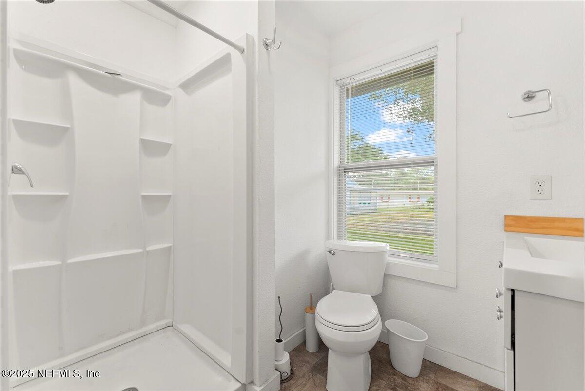 9034 Crystal Springs Road Jacksonville, FL 32221 - Photo 13 of 34 a white toilet sitting next to a bathroom sink and tub