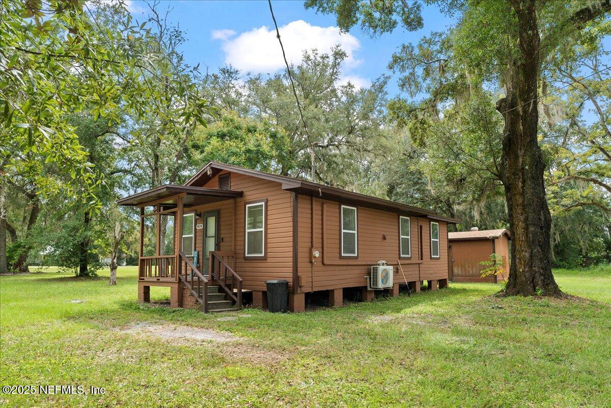 9034 Crystal Springs Road Jacksonville, FL 32221 - Photo 2 of 34 a view of a house with a yard