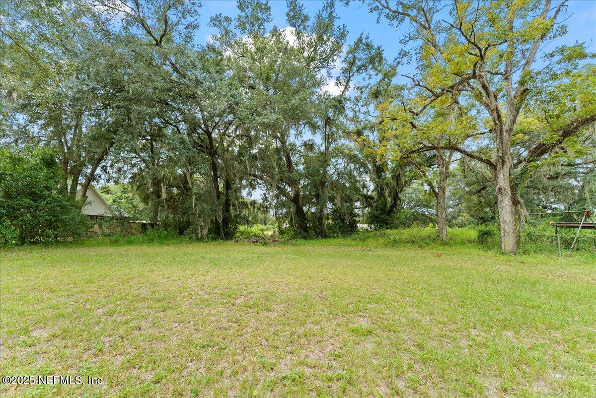 9034 Crystal Springs Road Jacksonville, FL 32221 - Photo 31 of 34 a view of a field with trees in front of it