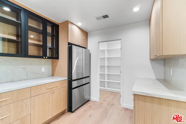 a kitchen with stainless steel appliances granite countertop a refrigerator and a sink