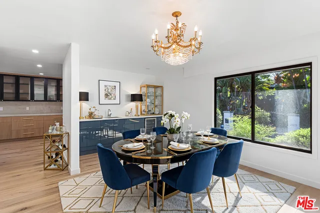 a view of a dining room with furniture a chandelier and wooden floor