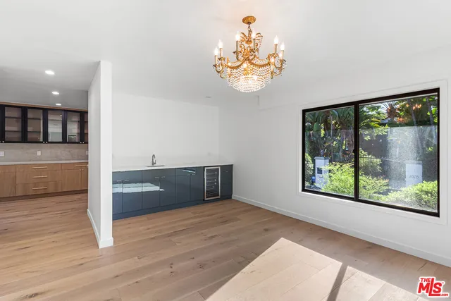 a view of a room with a window and chandelier