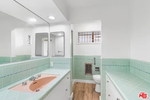 a bathroom with a tub sink and mirror