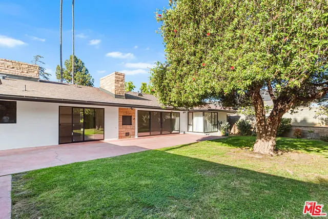 a view of a house with a yard porch and sitting area