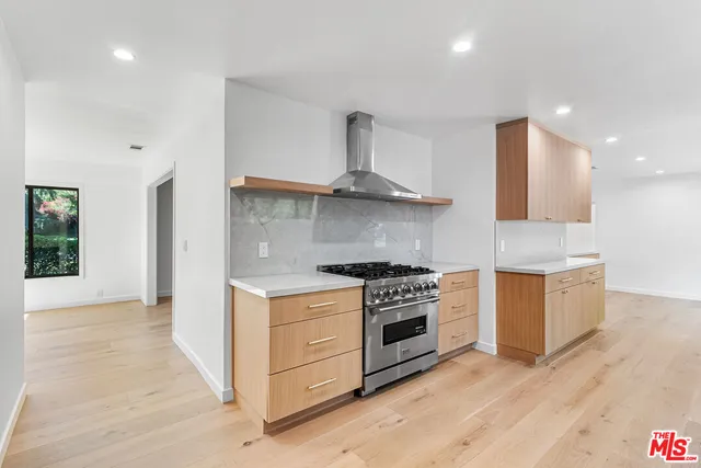a kitchen with stainless steel appliances a stove and a refrigerator
