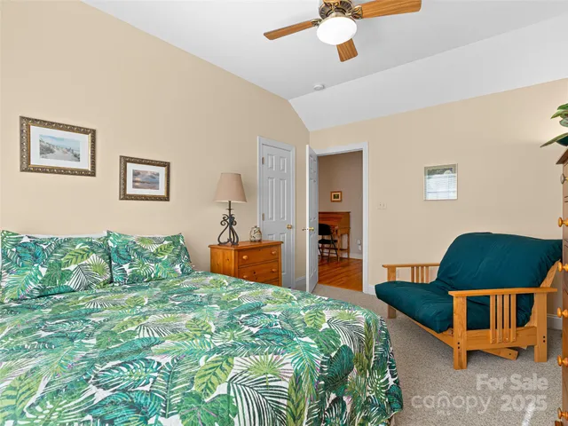 a bedroom with a bed a dresser and chair