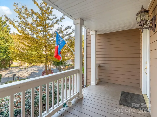 a view of a balcony with wooden floor and fence