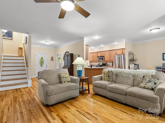 a living room with furniture and kitchen view