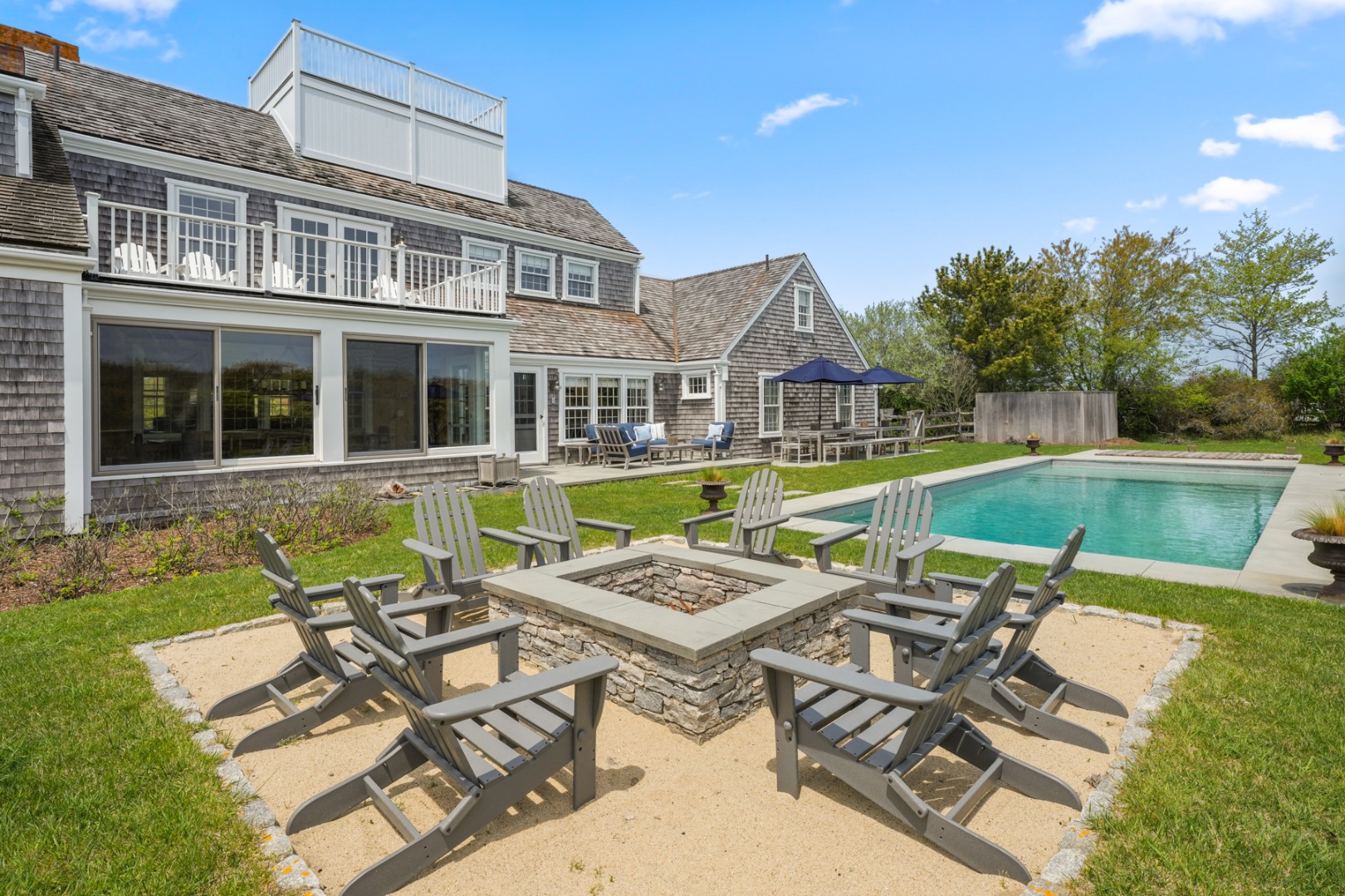 21 Quidnet Road Nantucket, MA 02554 - Photo 57 of 62 a view of a patio with couches table and chairs with swimming pool and outdoor seating