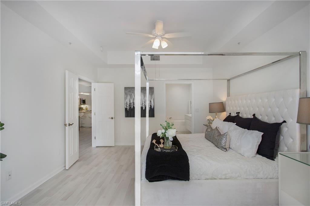 14560 Red Fox Run, Unit 515 Naples, FL 34110 - Photo 13 of 33 a bed room with a bed and a walk in closet