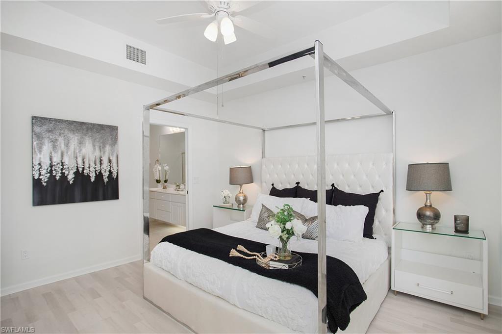 14560 Red Fox Run, Unit 515 Naples, FL 34110 - Photo 14 of 33 a living room with furniture and a mirror