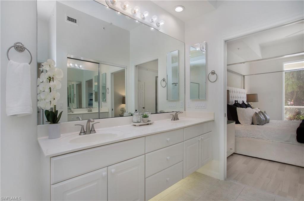 14560 Red Fox Run, Unit 515 Naples, FL 34110 - Photo 16 of 33 a en suite bathroom with double sink and a mirror