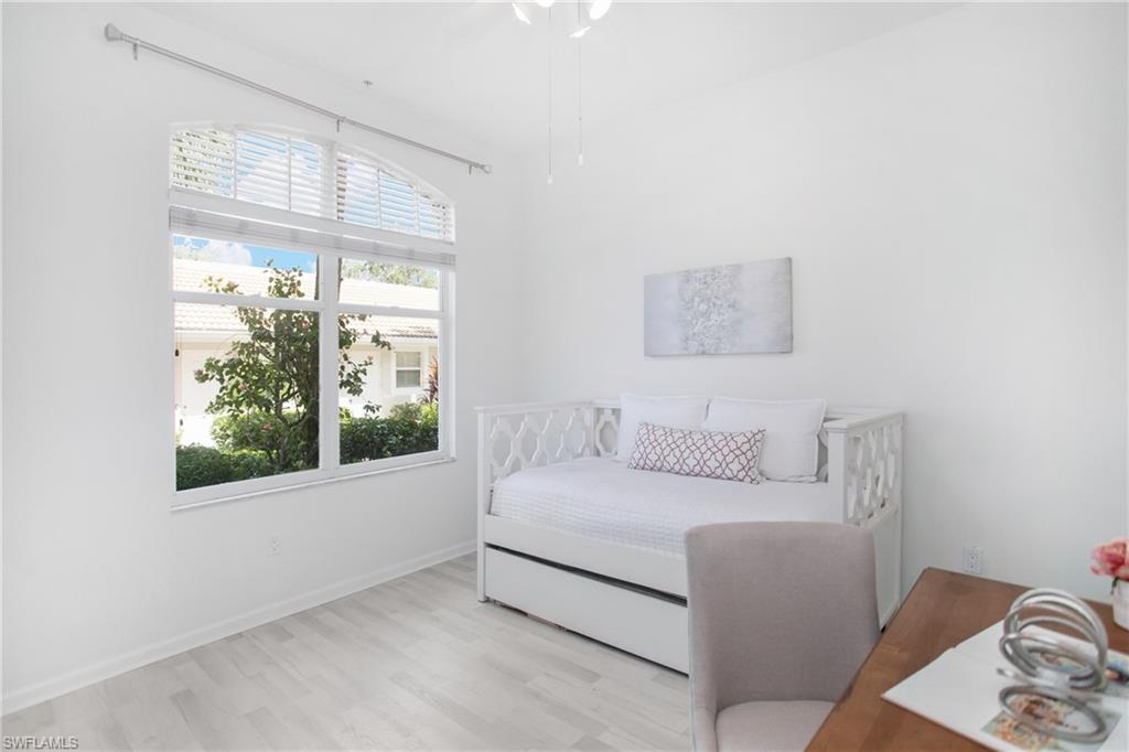 14560 Red Fox Run, Unit 515 Naples, FL 34110 - Photo 17 of 33 a living room with furniture and a window