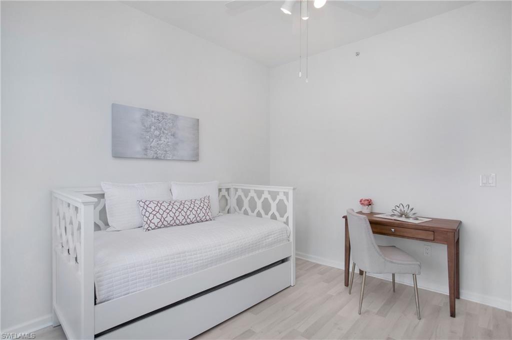 14560 Red Fox Run, Unit 515 Naples, FL 34110 - Photo 18 of 33 a white couch sitting in a bedroom next to a chair