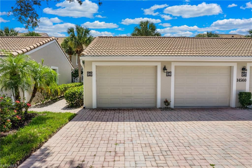 14560 Red Fox Run, Unit 515 Naples, FL 34110 - Photo 29 of 33 a front view of a house with a yard