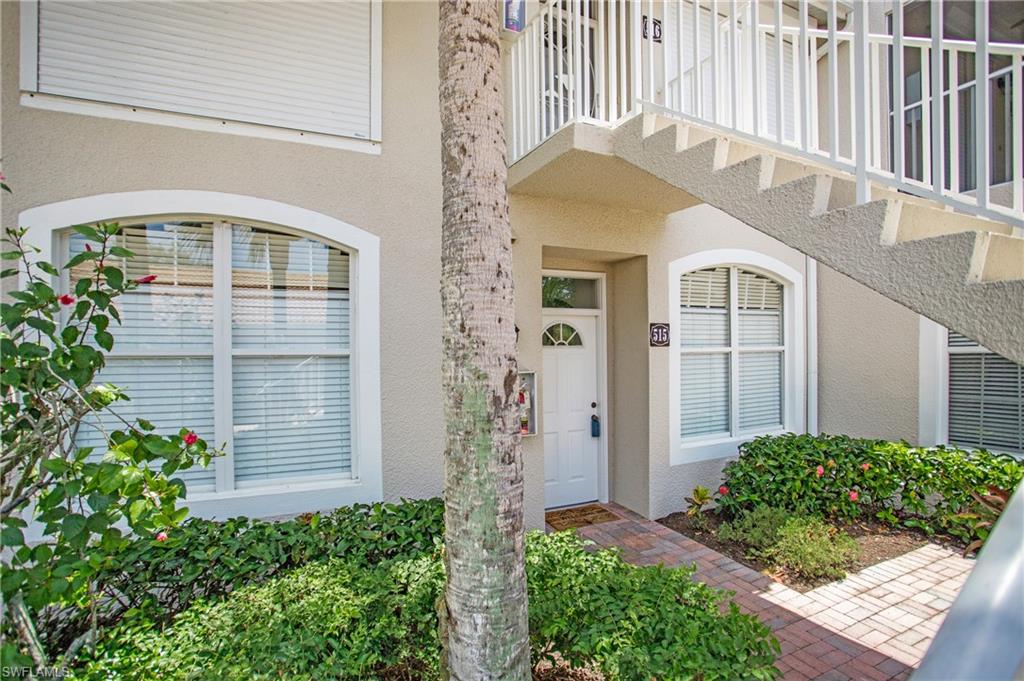 14560 Red Fox Run, Unit 515 Naples, FL 34110 - Photo 30 of 33 a front view of a house with a yard