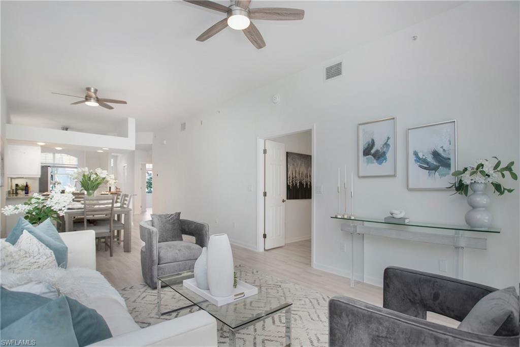 14560 Red Fox Run, Unit 515 Naples, FL 34110 - Photo 3 of 33 a living room with furniture and a fireplace