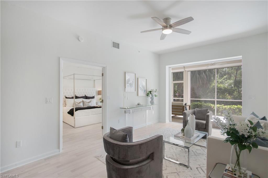14560 Red Fox Run, Unit 515 Naples, FL 34110 - Photo 7 of 33 a living room with furniture and a large window with garden view