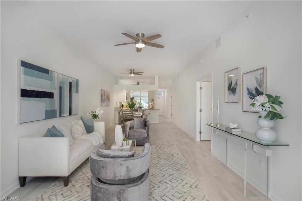 14560 Red Fox Run, Unit 515 Naples, FL 34110 - Photo 8 of 33 a living room with furniture and a potted plant