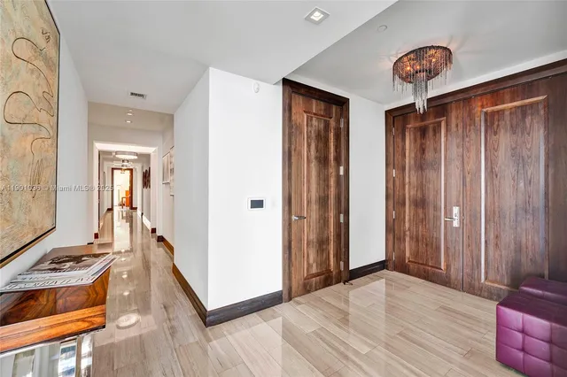 a view of a dining room with furniture wooden floor and a chandelier
