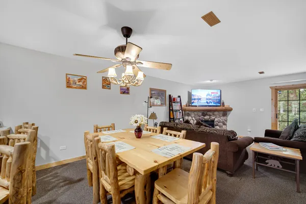 a view of a dining room with furniture and a chandelier