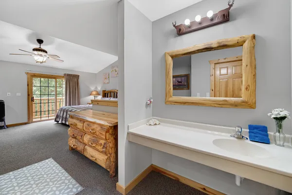 a en suite bathroom with a double vanity sink and a mirror