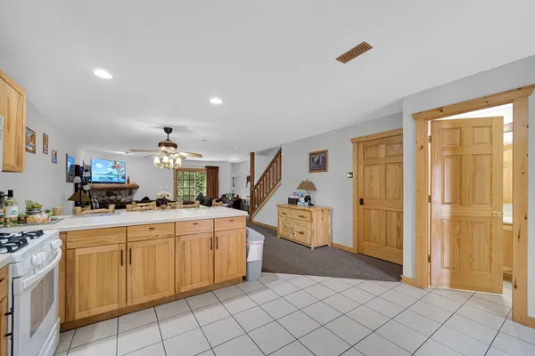 a kitchen with white cabinets and appliances