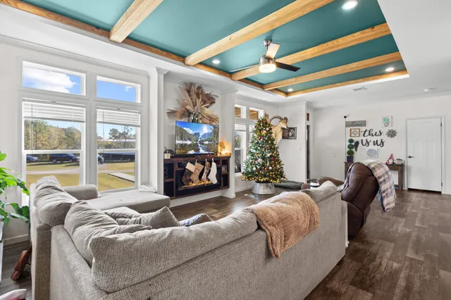 a living room with furniture and a floor to ceiling window