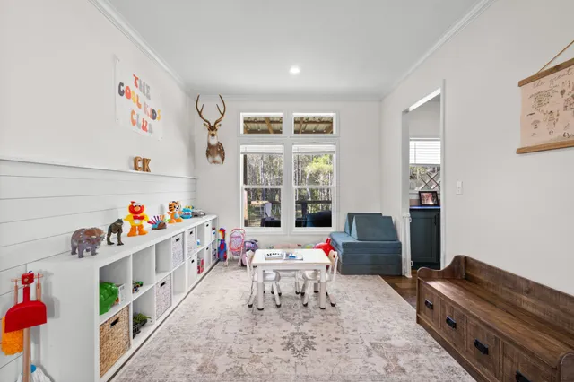 a room with furniture and baby crib