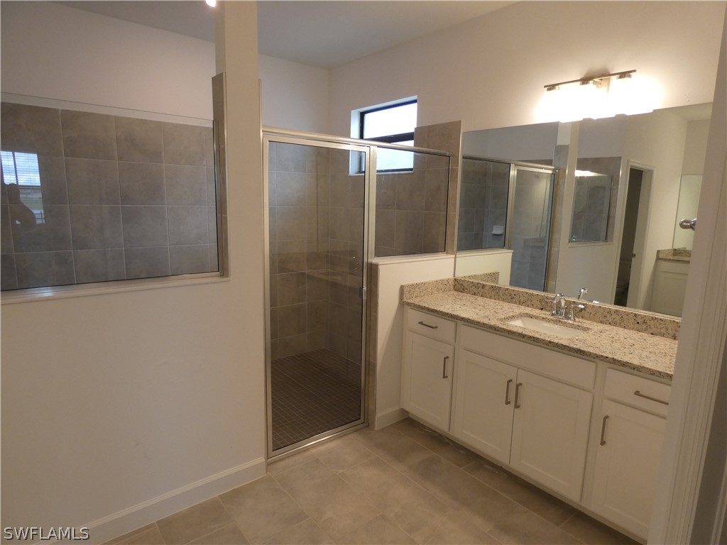 11379 Canopy Loop Fort Myers, FL 33913 - Photo 12 of 24 a bathroom with a granite countertop sink a mirror and a shower