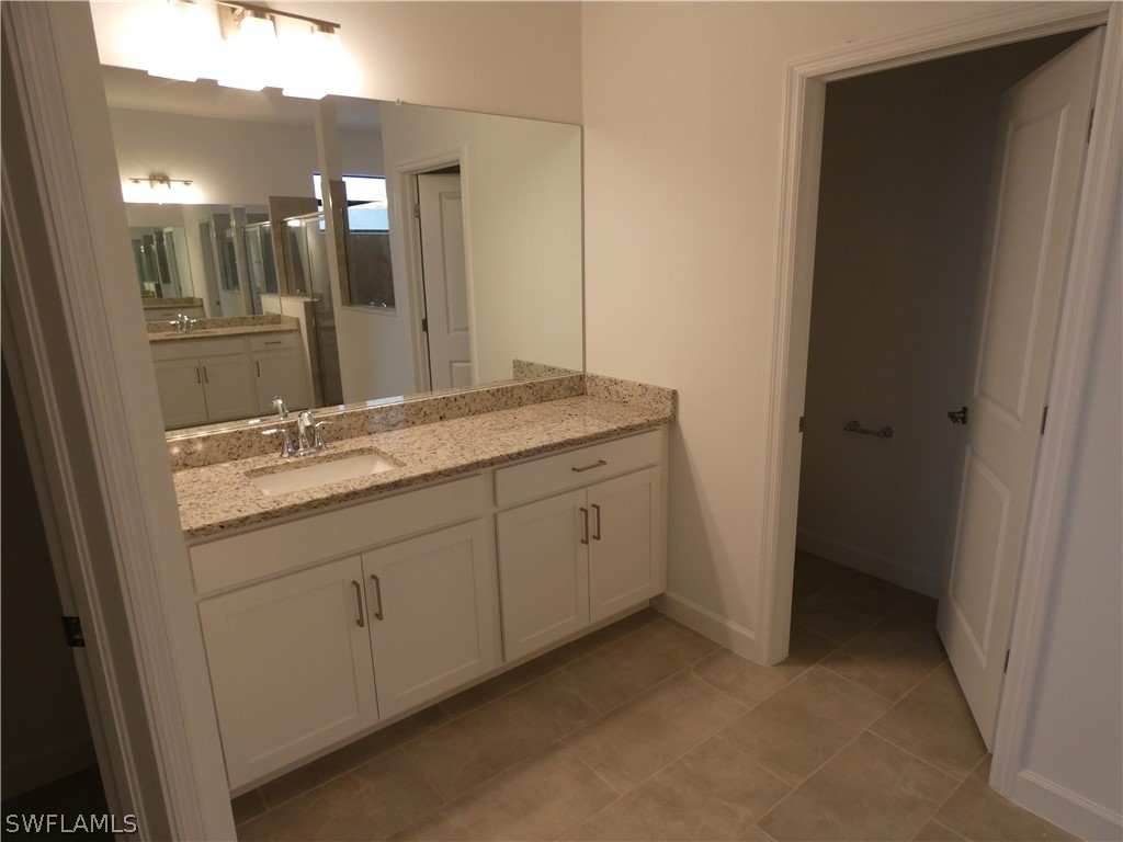 11379 Canopy Loop Fort Myers, FL 33913 - Photo 13 of 24 a bathroom with a granite countertop sink and a mirror
