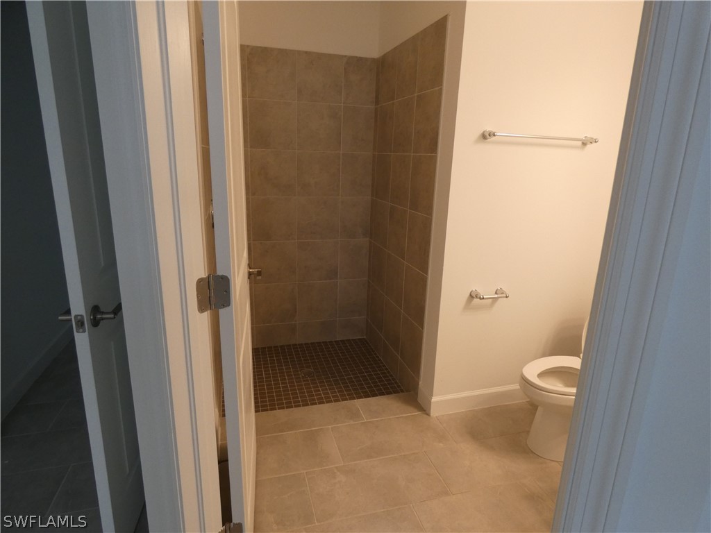 11379 Canopy Loop Fort Myers, FL 33913 - Photo 18 of 24 a bathroom with a granite countertop toilet and a shower