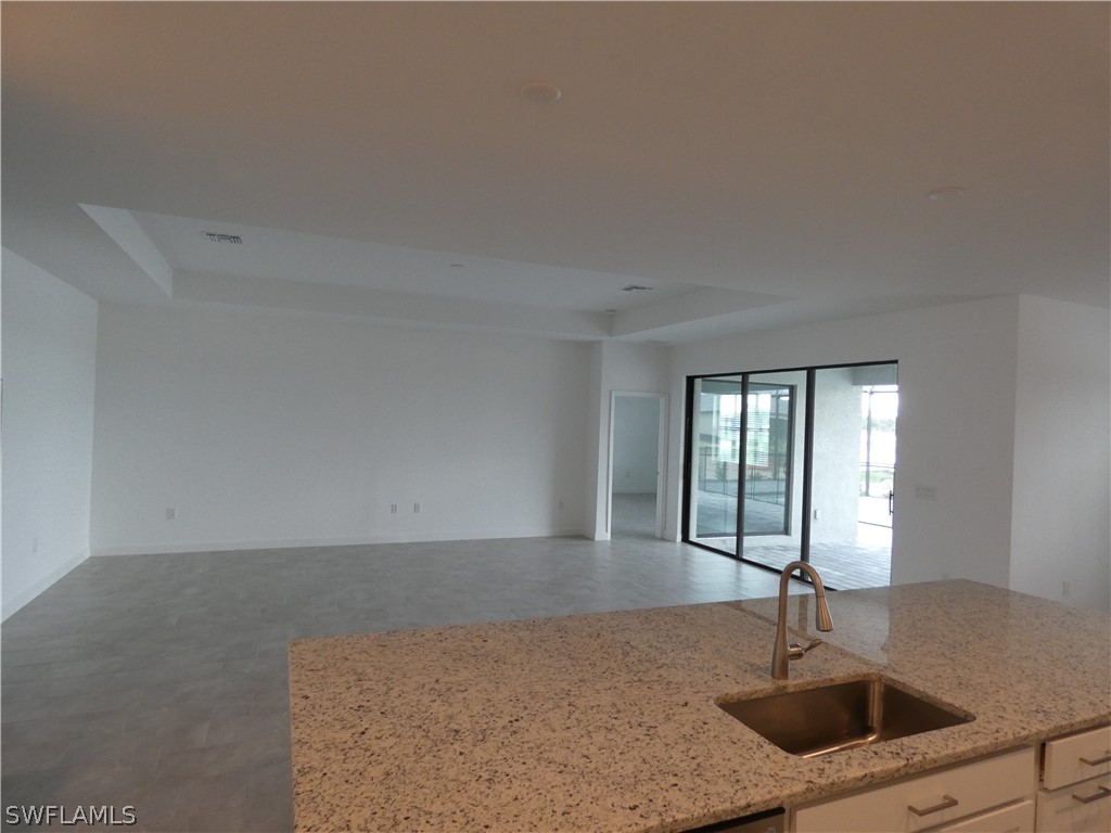 11379 Canopy Loop Fort Myers, FL 33913 - Photo 4 of 24 a kitchen with a sink a window and a couch
