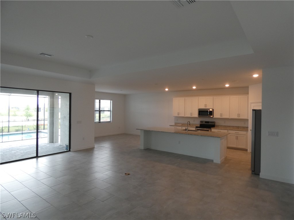11379 Canopy Loop Fort Myers, FL 33913 - Photo 6 of 24 a view of a kitchen with a sink and a large window