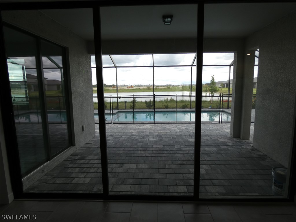 11379 Canopy Loop Fort Myers, FL 33913 - Photo 8 of 24 a view of empty room with wooden floor and floor to ceiling window