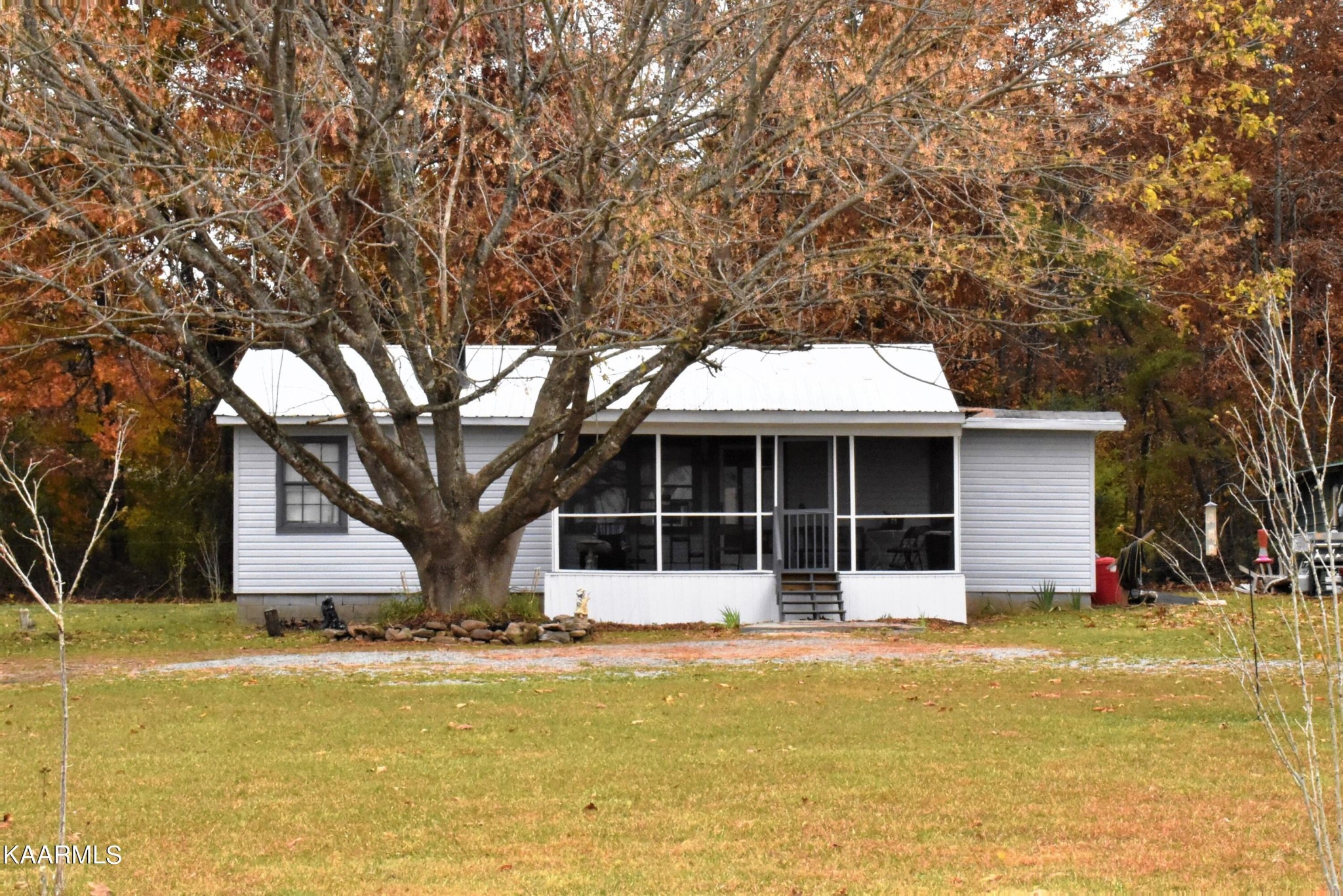 419 Stone Loop Crossville, TN 38571 - Photo 1 of 46 a front view of house with yard and trees around