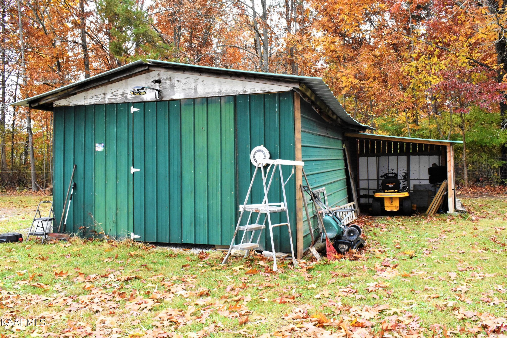 419 Stone Loop Crossville, TN 38571 - Photo 36 of 46 a view of a backyard with a cabin and a wooden fence