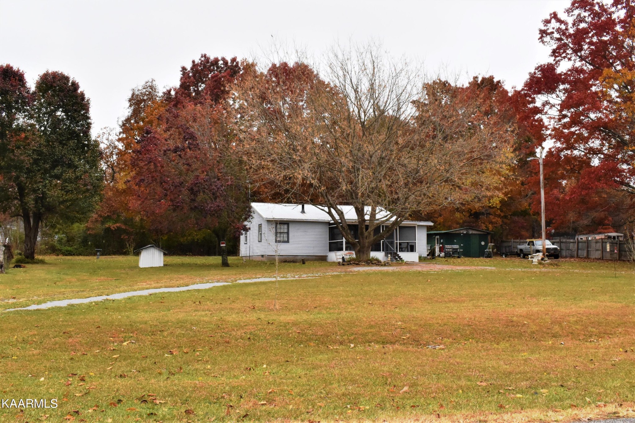 419 Stone Loop Crossville, TN 38571 - Photo 44 of 46 a view of a swimming pool with lawn chairs and large trees