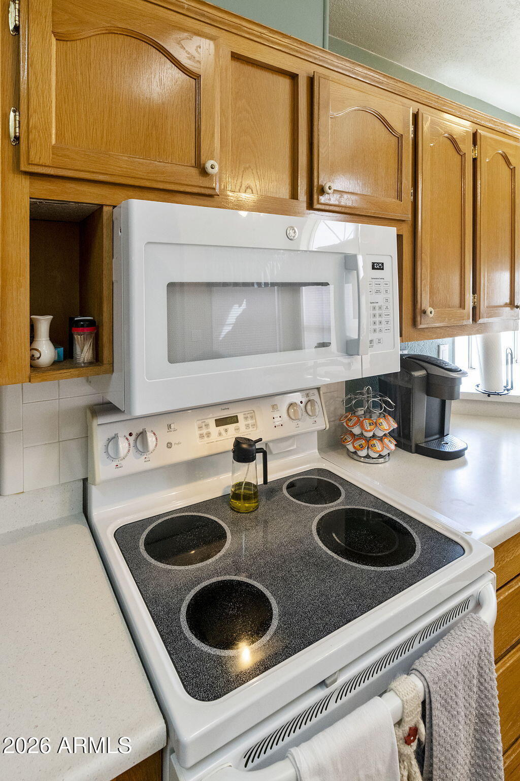 3700 South Tomahawk Road, Unit 23 Apache Junction, AZ 85119 - Photo 16 of 31 a kitchen with a stove and a sink