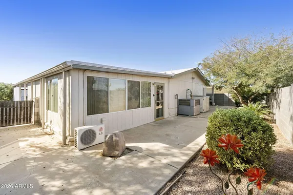 a view of a house with backyard and sitting area