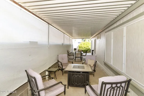 a dining room with furniture and a potted plant